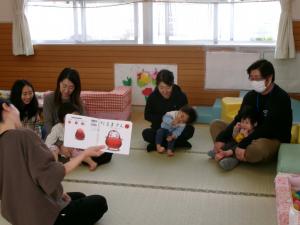 保育者に絵本を読んでもらう子ども達